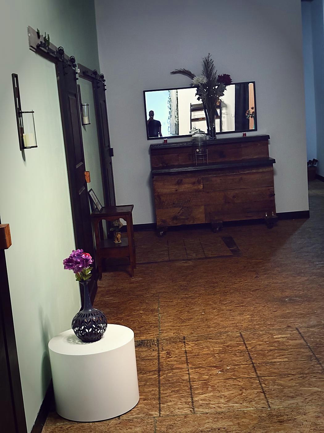 Corridor with mirror and fresh flowers